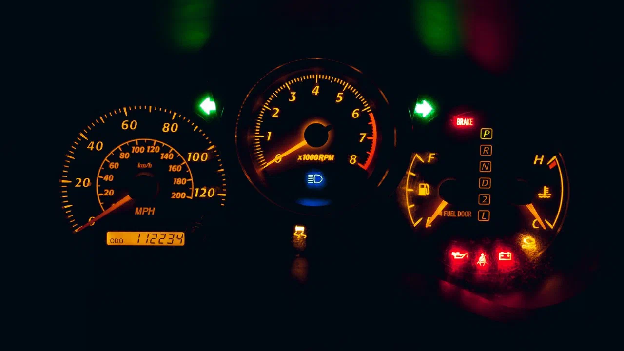 A car dashboard showing the speedometer and odometer