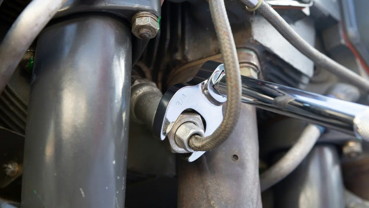 A black and gray metal wrench on a flat surface